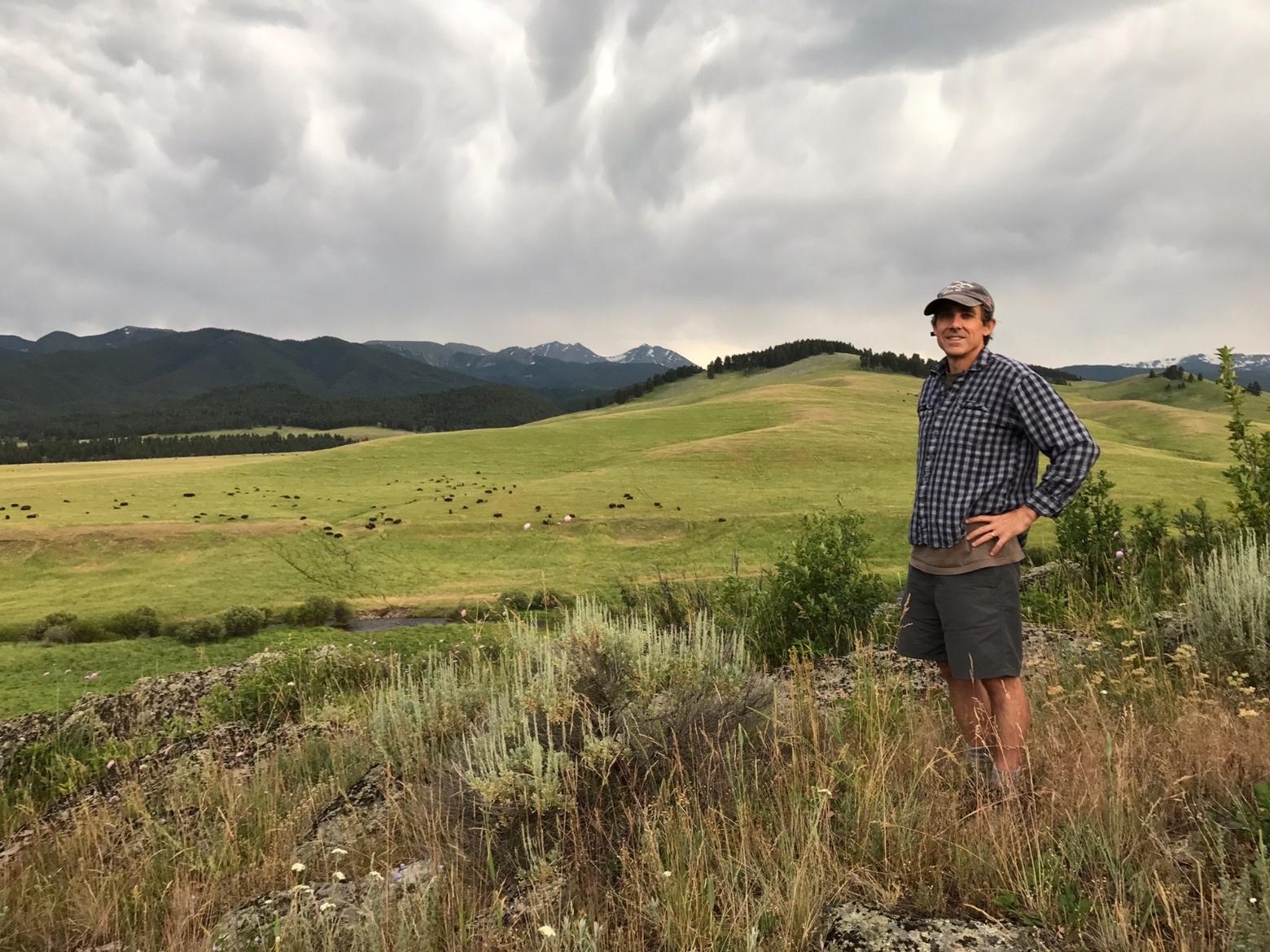 MoJo founder Todd Wilkinson scouting a Greater Yellowstone bison herd as a storm brews above.  Photo by Thomas D. Mangelsen