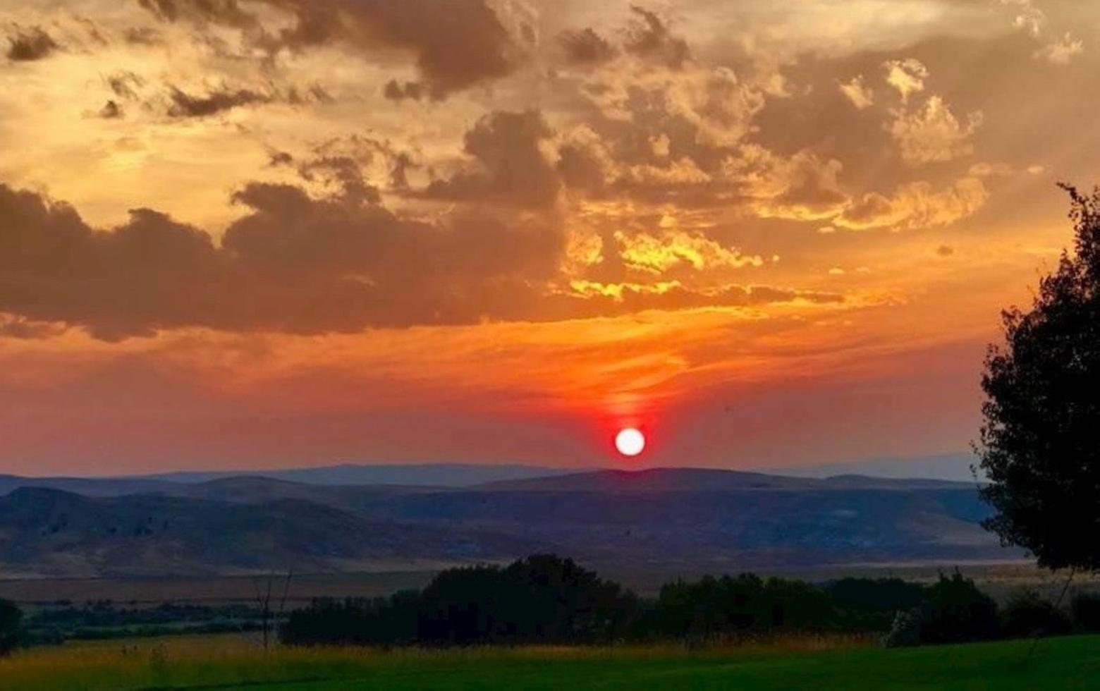 On the western flank of the Greater Yellowstone Ecosystem, a glorious awe-inspiring sunset unfolds from one of Ted Turner's ranches. At all of Turner's properties, where he raises bison, a major emphasis is placed on providing habitat for native public species, from grizzly bears to wolves, elk and trout.  Photo by Karen Averitt