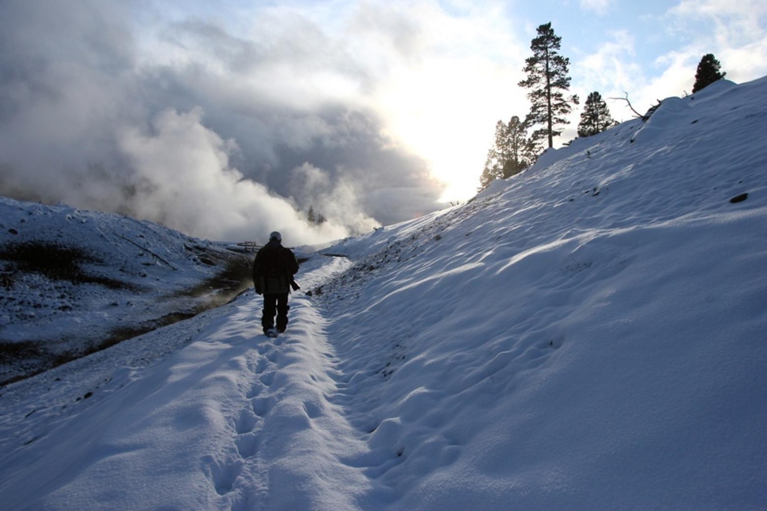 Winterkeeper Steven Fuller ventures into the geothermal mists of Yellowstone.  Photograph courtesy Kerry Huller (www.kerryhuller.com) for the Casper-Star Tribune