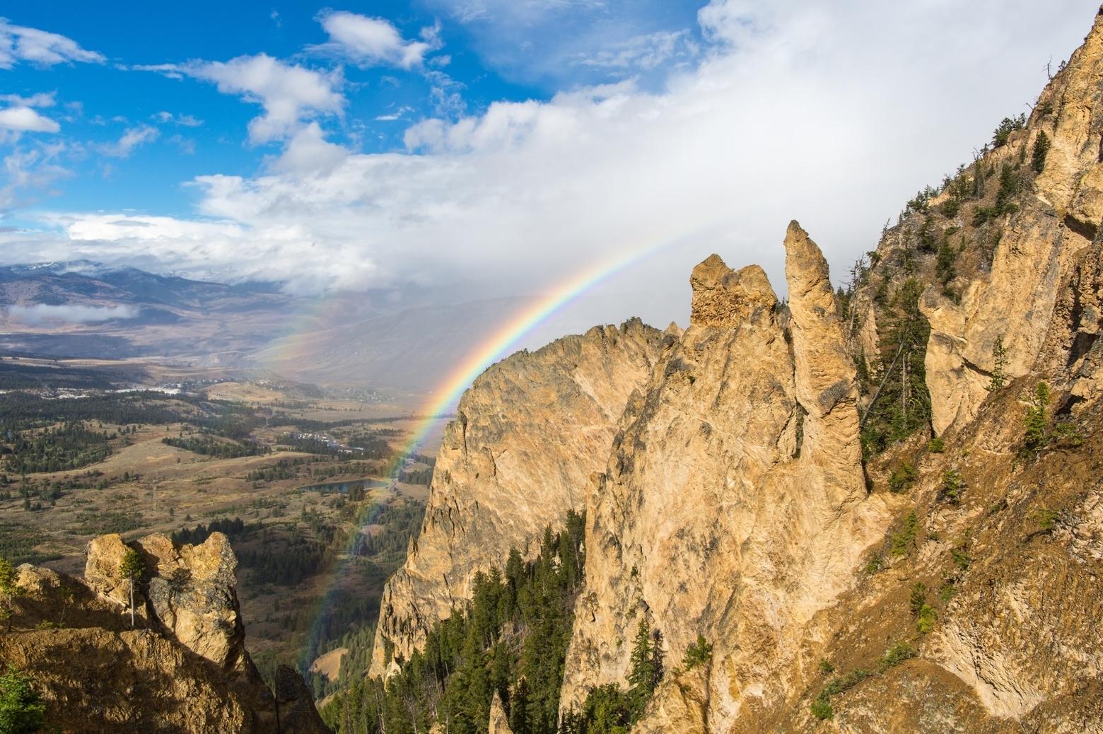 Rainbows from Bunsen Peak, Mammoth Hot Springs in the distance.  NPS / Neal Herbert