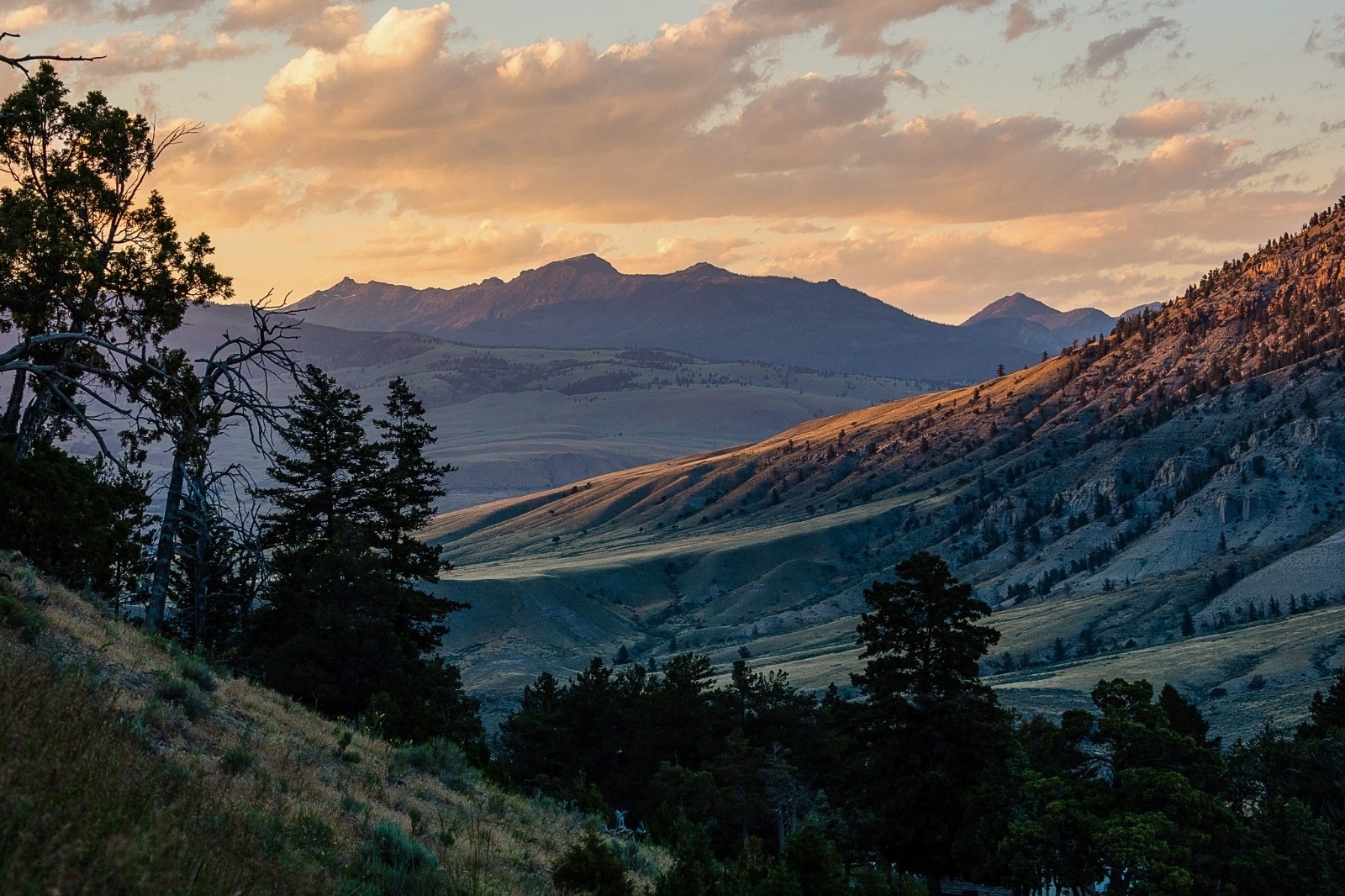 Monitor Peak at sunset—one view from Yellowstone headquarters at Mammoth Hot Springs. For Wenk, working as superintendent of Yellowstone was the highest honor a Park Service veteran could have and every day he didn't flinch or lament the controversies but saw them as a way to build upon Yellowstone's rising beloved status among American people. He saw flickers of light flash in the eyes of visitors when they realized the country's first national park belonged to them too.