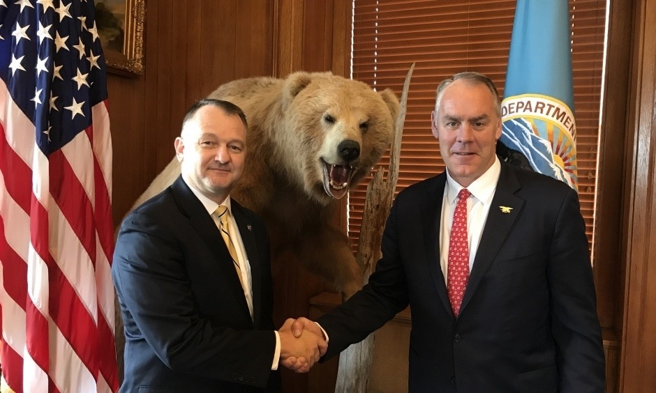 Interior Secretary Ryan Zinke gives Cameron &quot;Cam&quot; Sholly a congratulatory handshake after making him the next superintendent of Yellowstone. For Sholly, it is a homecoming.  He spent his high school years in the park while his father served as chief ranger. Photo courtesy U.S. Interior Department