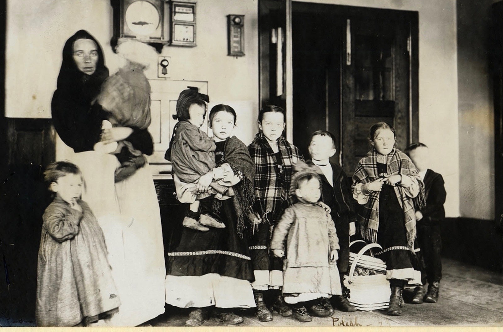 A Polish immigrant mother, not of great means or education, and her nine children pass through Ellis Island. Photograph courtesy National Park Service