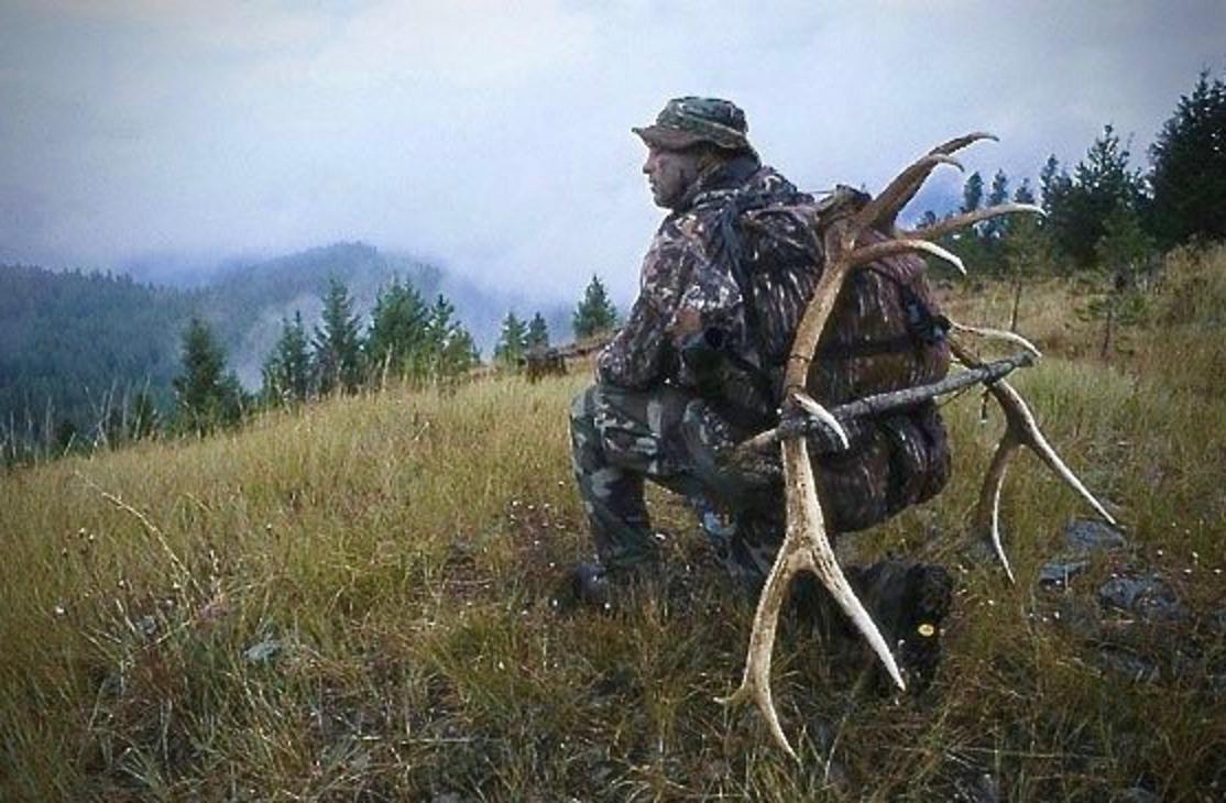 The author out in the backcountry bringing home a pack full of fresh elk meat for the winter and  the antlers of the bull he killed.  Photo by Bob Knoebel. 