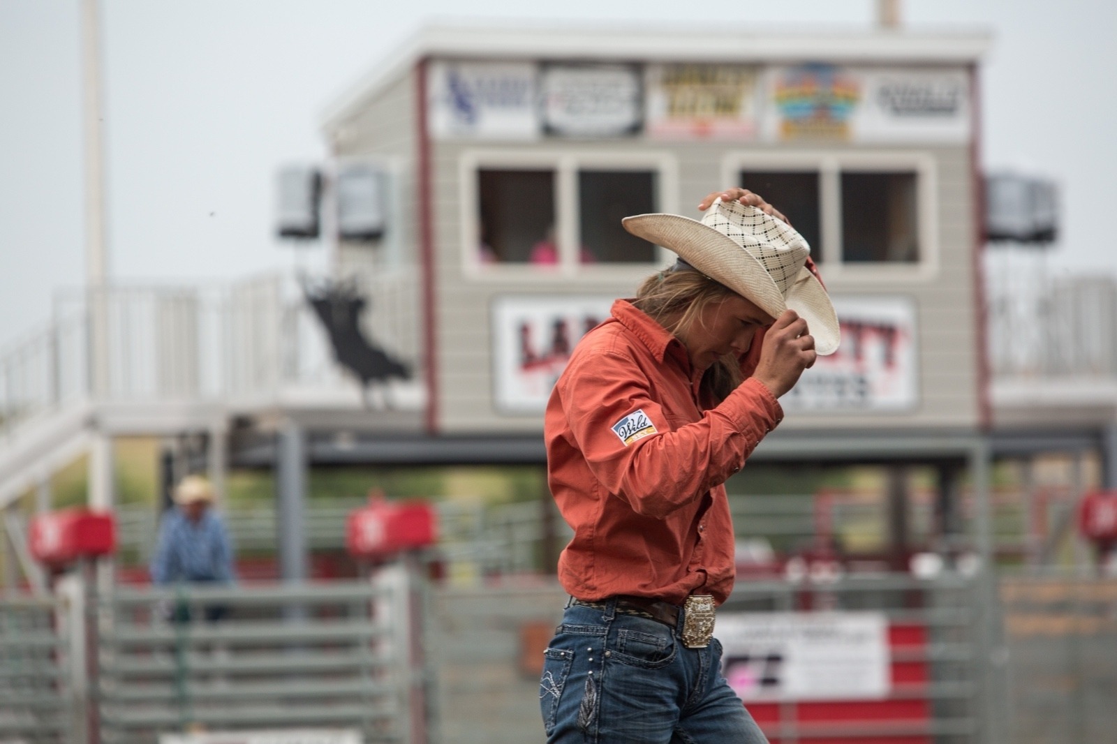 Top: Irene Johnson competes in the goat tying event at the Lewistown Rodeo in August 2018. Since she was 15 years old, Irene has been rodeoing on the Montana High School Rodeo Association. Middle: Johnson competes in the goat tying event at the Lewistown Rodeo in August 2018 then (just above) tucks her hat back on with a sense of accomplishment with horsemanship that is equal parts art and technical skill.  All photos by Louise Johns. 