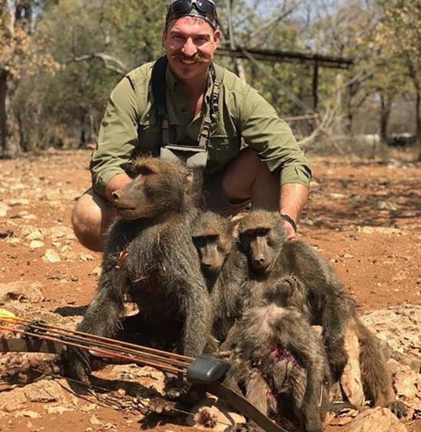 Former Idaho Fish and Game Commissioner Blake Fischer posing in the photo that resulted in his resignation and set off a global firestorm.  Following his outing, he circulated the photo with the message: "I shot a whole family of baboons."