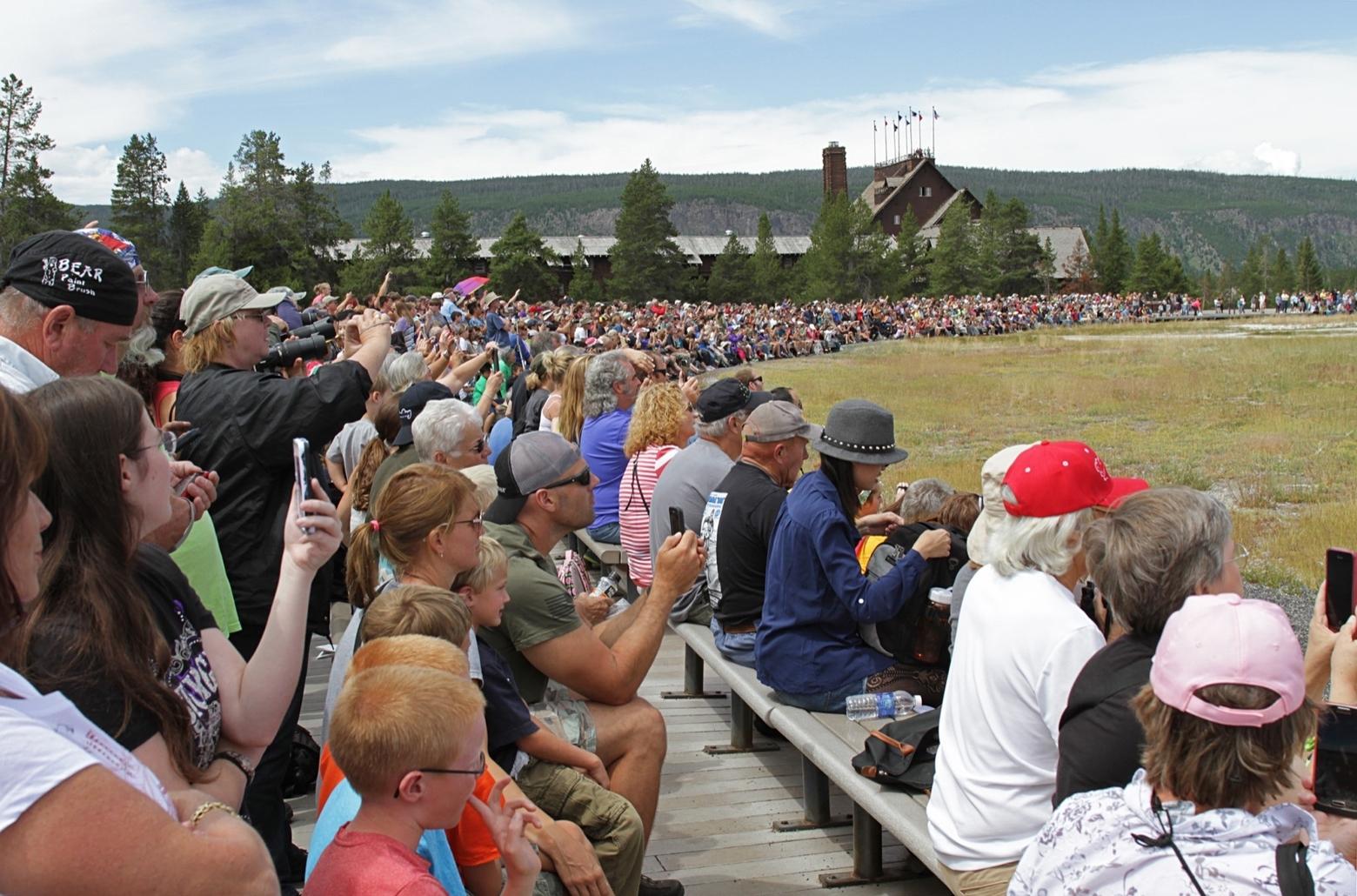 Top photo: A &quot;bison jam&quot; in Yellowstone's Hayden Valley—traffic gridlock caused by tourists moving through a bison herd—is a common occurrence in summer.  Image courtesy Jacob W. Frank/NPS.  Middle photo::  Summer crowds move along the boardwalks encircling Old Faithful Geyser and other features in the Upper Geyser Basin. Image courtesy Neal Herbert/NPS.  Immediately above here:  Visitors from around the world wait for Old Faithful to erupt. Image courtesy Jim Peaco/NPS