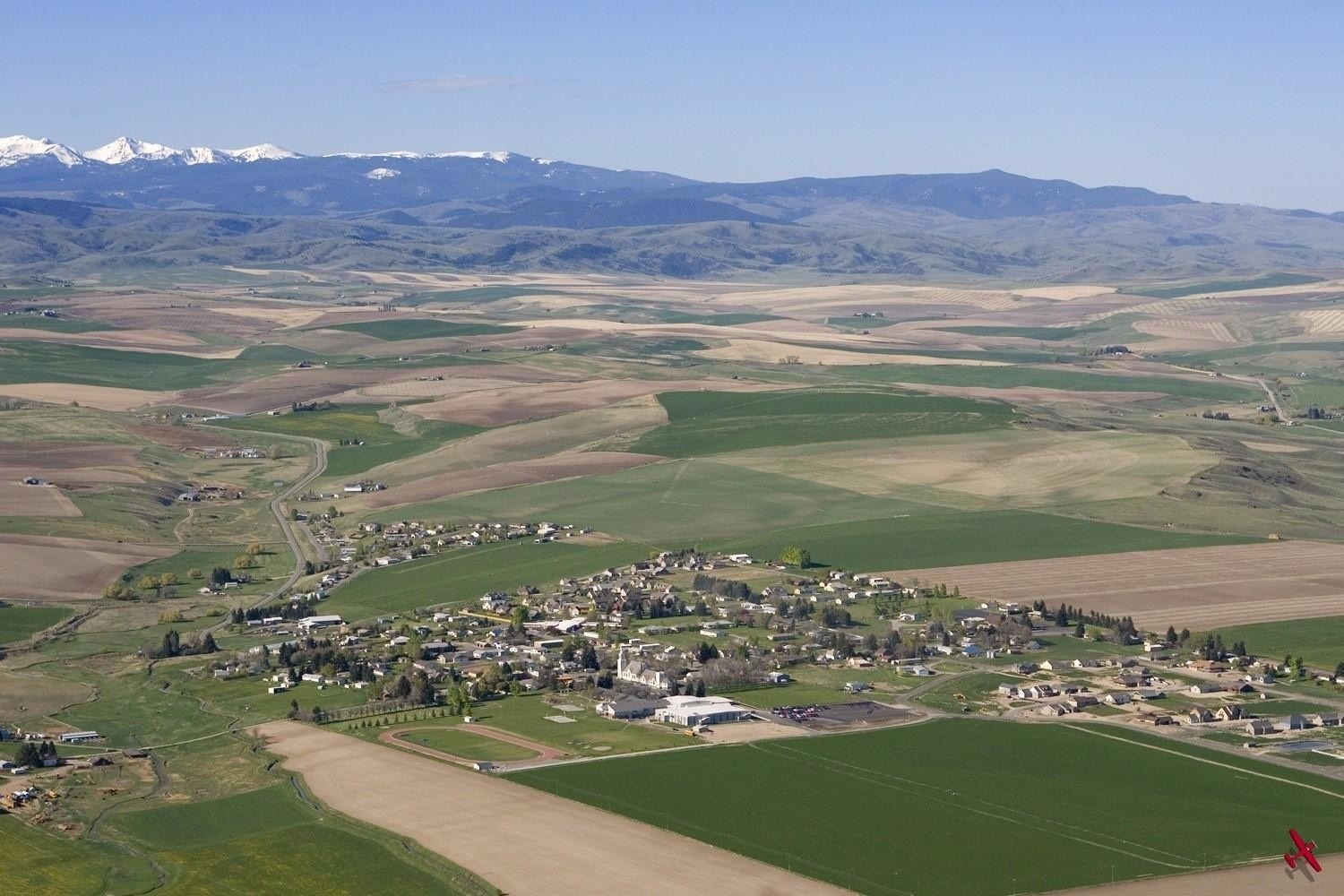 The farming community of Churchill in the middle of the Gallatin Valley.  Is this vision from the past a model for how to cluster growth in the future?  Churchill stands in sharp contrast to the scattershot development patterns sweeping across the Gallatin Valley from Bozeman.