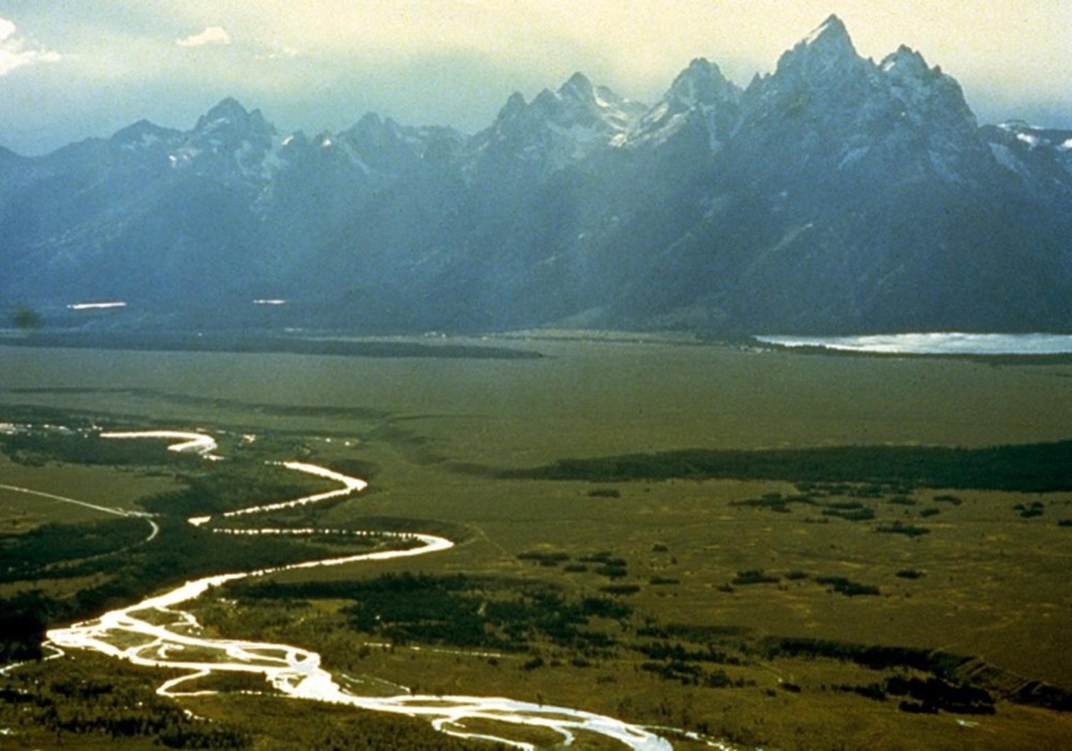 The river known as Ki-moo-e-nim and Yam-pah-pa to the Shoshone tribe, cuts a serpentine course through Jackson Hole beneath the Tetons. While white people coming into the country named it the Snake River, the aboriginal name referenced an herb that grows prolifically along its banks. Photo courtesy Wikipedia
