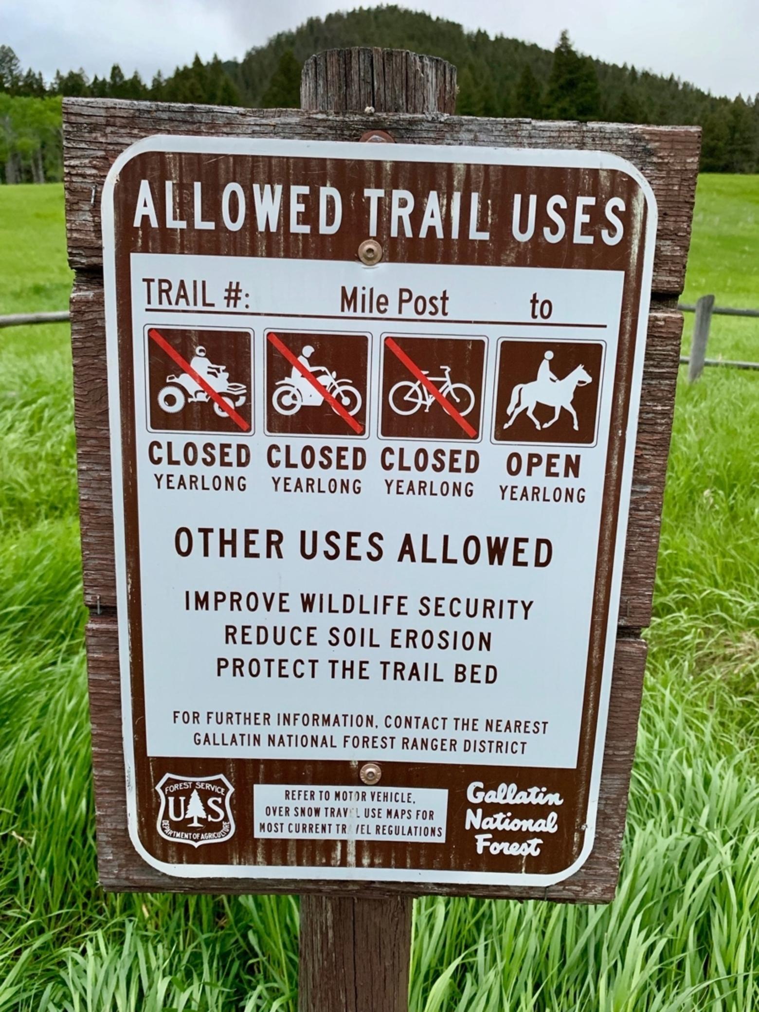 A sign at a Custer-Gallatin National Forest trailhead on the east side of the Madison Mountains and an entryway to the Lee Metcalf Wilderness.  One of the reasons cited for yearlong closures of mechanized vehicles is to "improve wildlife security."  Mountain Journal photo.