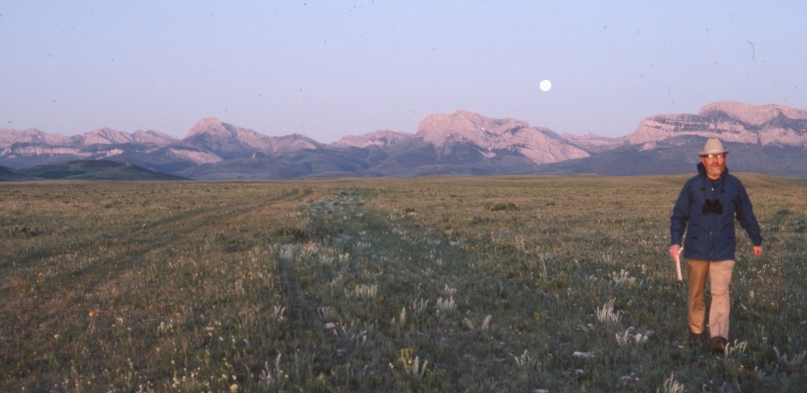Doig pacing off shadow at dawn along the Rocky Mountain Front. Photo by Carol Doig, courtesy MSU Library Doig Collection