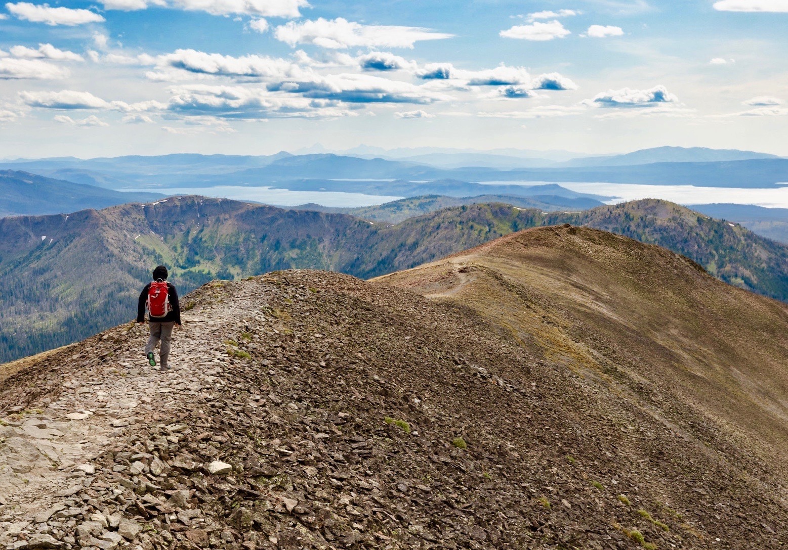 A hiker in the high country of Yellowstone—Yellowstone Lake in the distance. Photo by Jacob W. Frank/NPS