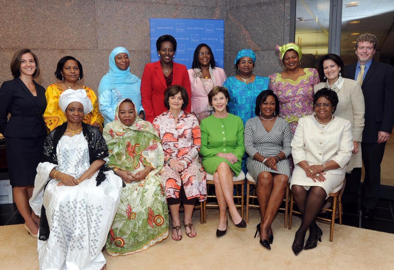 Neumann (top row, far left) with First Ladies from the world, including Laura Bush (center, in green). who are involved with a group she founded, the Global First Ladies Alliance. The organization includes First Ladies from six continents. Photo courtesy RAND