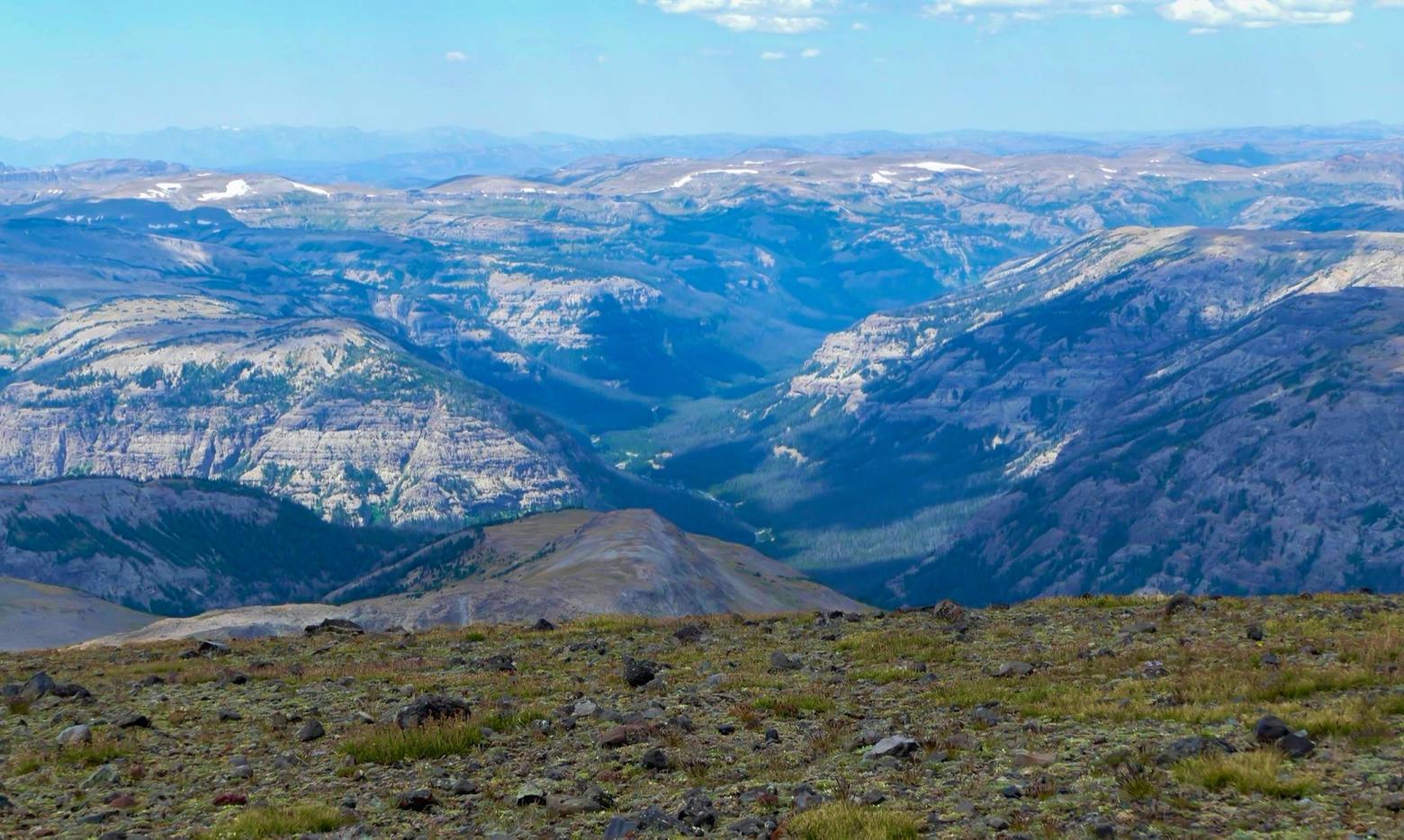 Most of all, Yochim appreciated entering the roadless Thorofare, one of the most remote places in the Lower 48 and formed by an intersection of national park and forest. This photograph offers a view of the headwaters of the Yellowstone River looking west from the top of Younts Peak in the Teton Wilderness of the Bridger-Teton National Forest south of Yellowstone. The North Fork and the South Fork of the Yellowstone river collect snowmelt from Younts Peak and meet just to the west of the mountain where the famous river begins its journey northward through the park. The area is home to many solitude-needing species free from large numbers of people. Photo courtesy Yellowstone National Park. 
