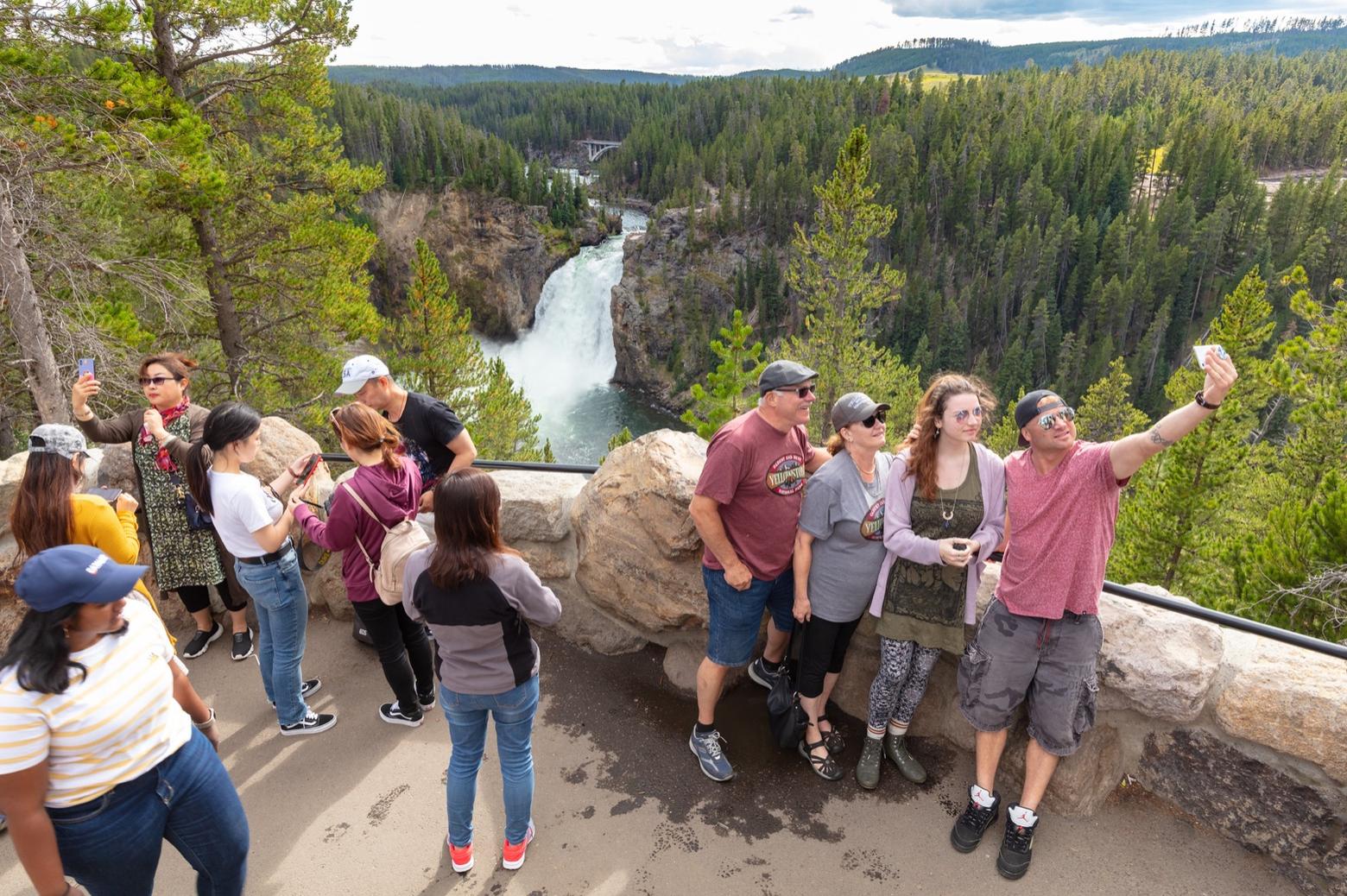 Tourists gathered for selfies with the Upper Falls near Canyon Village behind them.  Photo courtesy Jacob W. Frank/NPS