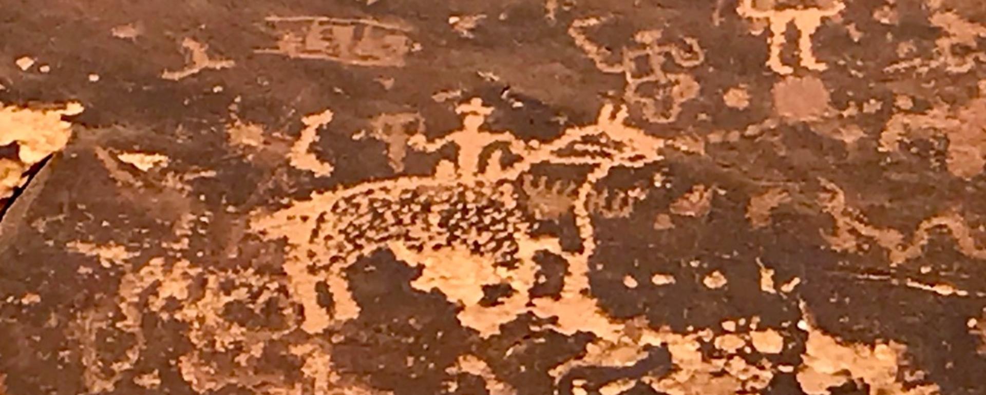 A cowboy petroglyph written over ancient art predating it