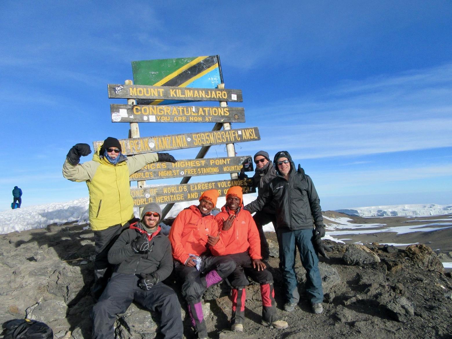 Only months ago, the author (in yellow jacket) and friends stood on the top of Mt. Kilimanjaro in Tanzania, at 19,341 feet the tallest summit in Africa.  Like the still wildlife-rich Serengeti Plain, Knight says the diversity of wildlife in Greater Yellowstone, his home region, is a miracle that needs safeguarding. Photo courtesy Phil Knight