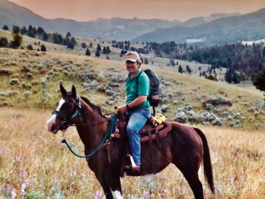 Bart Koehler saddled up for a ride into the Porcupine in 1993 with the crest of the Gallatins rising in the distance. Some call the drainage "the Holy Land" for its incredible diversity of wildlife and its role as a corridor for migratory elk and other species moving in and out of nearby Yellowstone National Park.  Photo courtesy Bart Koehler