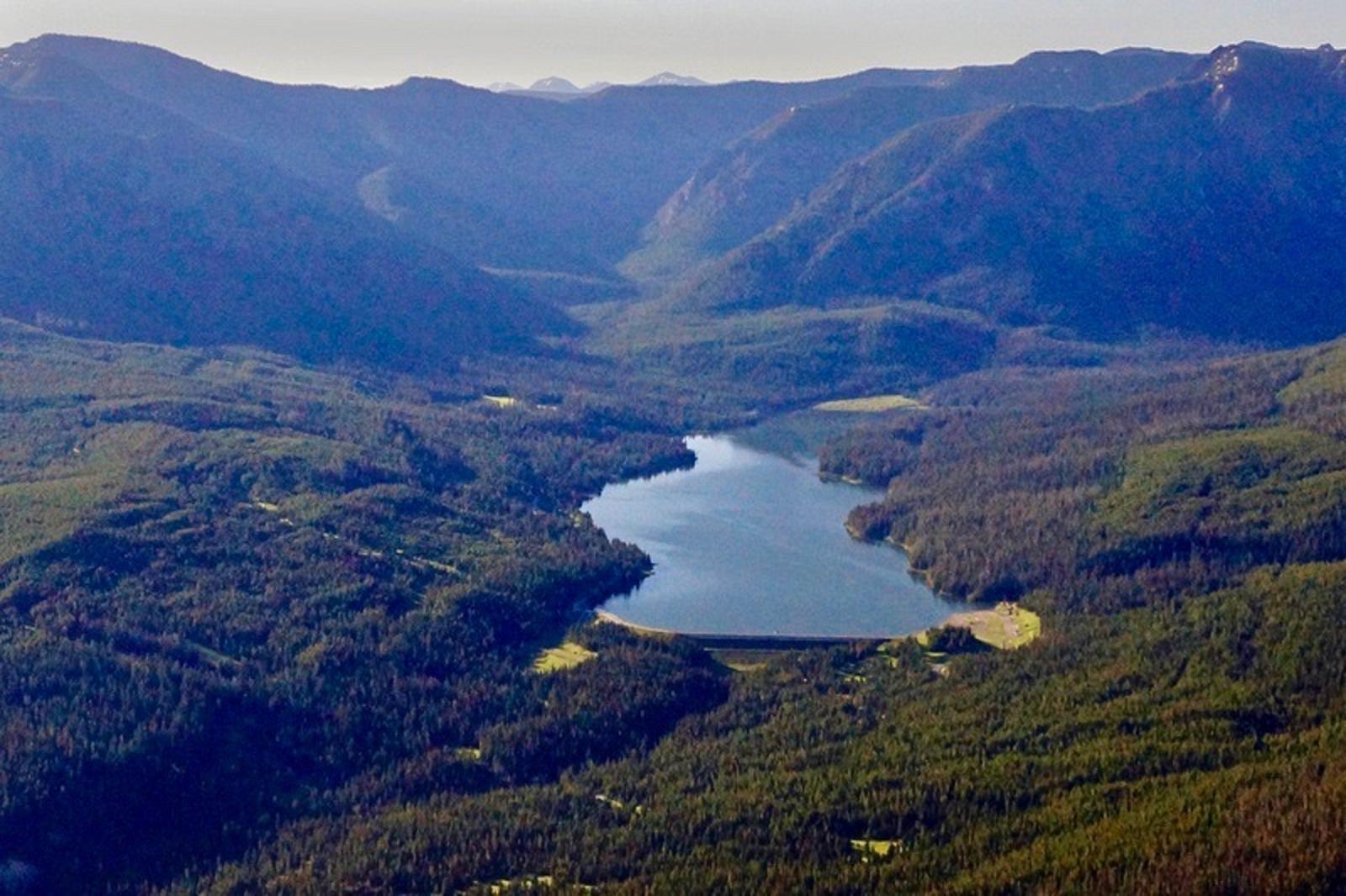 An aerial view of Hyalite Reservoir and a view looking south down the line of the Gallatins that extends into Yellowstone Park. The Custer-Gallatin National Forest is one of the most visited national forests in the country and Hyalite Reservoir south of Bozeman is the busiest recreation complex on the forest. The Gallatin Forest Partnership anticipates that under its plan the Porcupine-Buffalo Horn could generate use levels as intense as those on trails near Hyalite. 