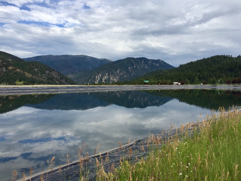 That's not a tranquil, gin-clear lake with the Gallatin mountains reflected on its surface. It's the massive sewage treatment lagoon in Big Sky and its limited capacity is one of many growth-related challenges facing the community. Photo by Todd Wilkinson 