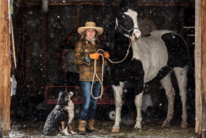 Malou Anderson-Ramirez getting ready to saddle up for a snowy ride in Tom Miner Basin, located in the Gallatin Mountains just north of Yellowstone National Park. Photo courtesy