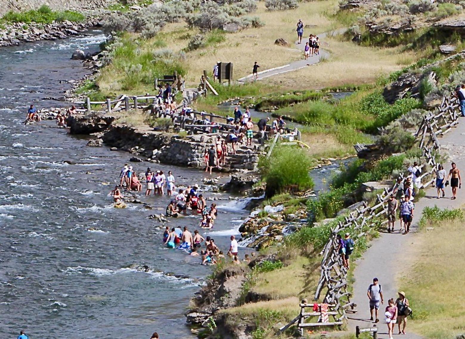 The summer throngs descend upon Boiling River in Yellowstone. The geothermal soaking site swells with visitors in summer. And, it just happens to reside within a wildlife migration corridor used by elk, bison, mule deer and bighorn sheep.  Everybody wants to have fun and soaking at Boiling River is an exotic experience. Having fun is good for our physical and mental health. But the mere act of being an outdoor recreationist does not make one a conservationist.  Photo courtesy Jim Peaco/NPS