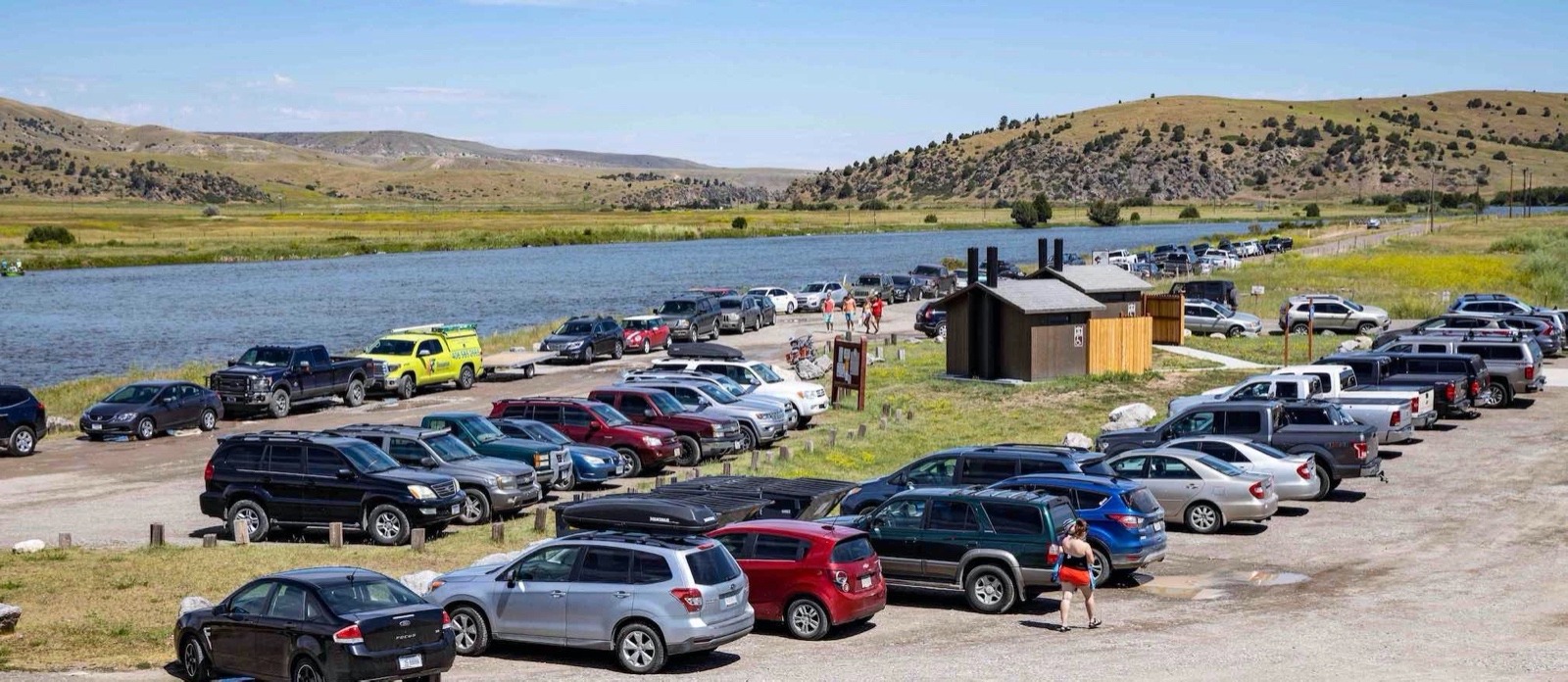 This is actually the scene of a slow day at a take-out when tubers upstream took to the Madison River west of Bozeman this summer. Whereas this middle stretch attracts thousands upon thousands of floaters on inflatables and stand up paddle boards, the Upper Madison is dealing with its own issues, involving conflict between recreational anglers, commercial operators and others who say heavy fishing pressure and hooking mortality, along with hot summers bringing lower flows and warmer water, is certain to, at some point, negatively impact the wild, naturally-reproducing trout fishery. Photo by Todd Wilkinson