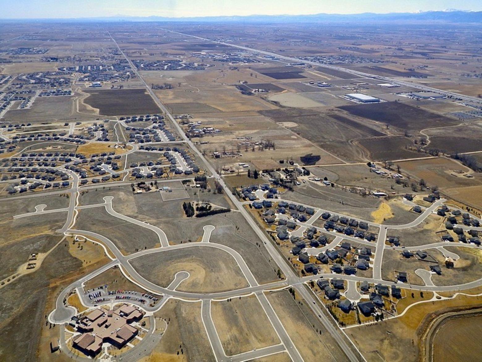 Photo at top: Full-field energy development permitted by the federal Bureau of Land Management in the Pinedale Anticline and Jonah Field just off the west side of the Wind River Range in the Upper Green River Basin. Oil and gas drilling has shows to have huge impacts on migratory pronghorn and mule deer as well as imperiled  Greater sage-grouse.  The image beneath it is an aerial overview of Superior, Colorado, a bedroom community of Boulder, Colorado that grew from 255 people in 1990 to more than 11,000. This community has created almost no jobs and no sales tax base, putting a huge strain on local government, i.e. taxpayers. Both energy development and housing sprawl destroy wildlife habitat. What's the difference? Oil and gas wells eventually go away. Subdivisions are forever.  Photos courtesy Ecoflight (ecoflight.org)