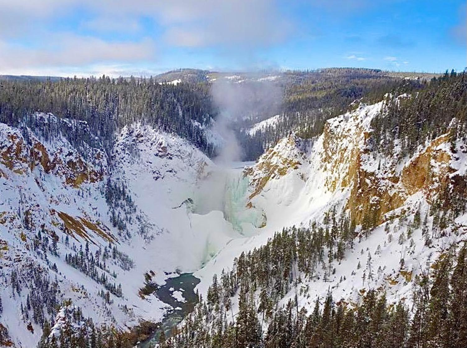 The mighty Grand Canyon of the Yellowstone and its signature focal point, the Lower Falls, has been left to a more muted roar in the aftermath of several days in which the mercury reading remained well below zero. The waterfall is seen in a pastel green sheath, with mist rising as flows from the Yellowstone River tumble into the cold, cold air, turning mist into ice crystals.