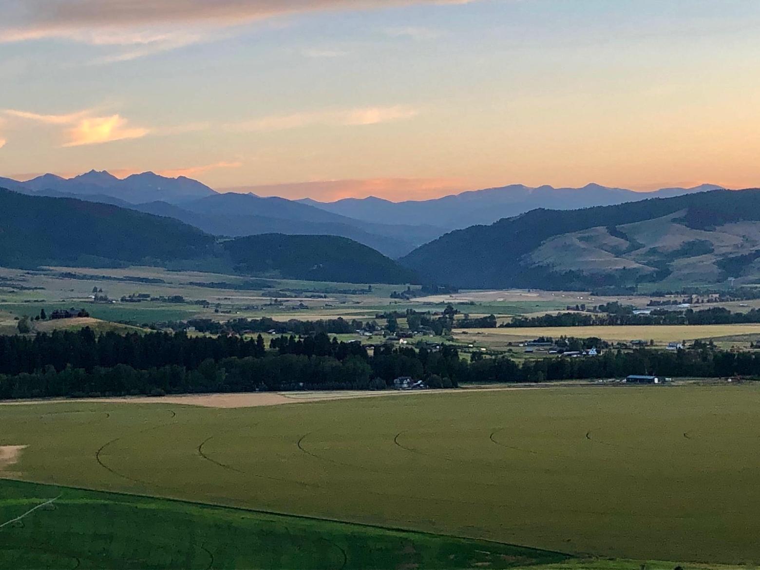 Looking toward Gallatin Canyon that divides the Gallatin Range from the Madison mountains, this sweep of ag land provides key habitat for migratory elk and mule deer moving between the Gallatins and Ted Turner's Flying D Ranch, visible in the upper right of the photograph.  As author Sisson notes, a proposed development could result in closure of the crucial migration corridor. The issue also exposes how the government bodies of both Gallatin County and Bozeman have no coordinated strategy for saving the best remaining wildlife habitat in the face of high population growth. Photo courtesy Rob Sisson