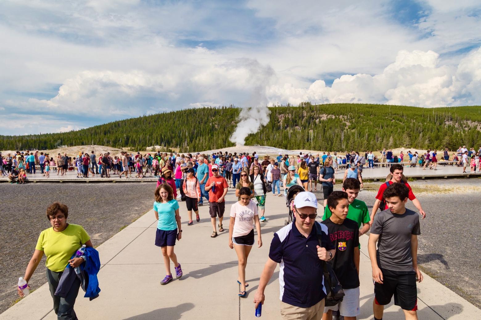 Summer visitors to Yellowstone depart after watching Old Faithful erupt for a few minutes. We all passionately love Yellowstone; it's a fact. But does our experience seeing the world's most famous geyser erupt change how we think about nature?  A human-built industrial infrastructure encircles the geyser itself and the physical human footprint dwarfs it in size. How is this a metaphor for the kinds of things Popkin addresses in his new book? Photo courtesy Jacob W. Frank/NPS 