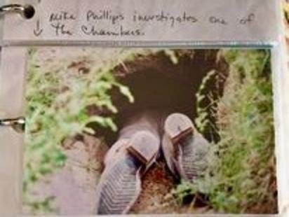 Only Mike Phillips' feet are visible after he examines the far end of a wolf den in Yellowstone National Park two decades ago. Photo courtesy Holly Pippel