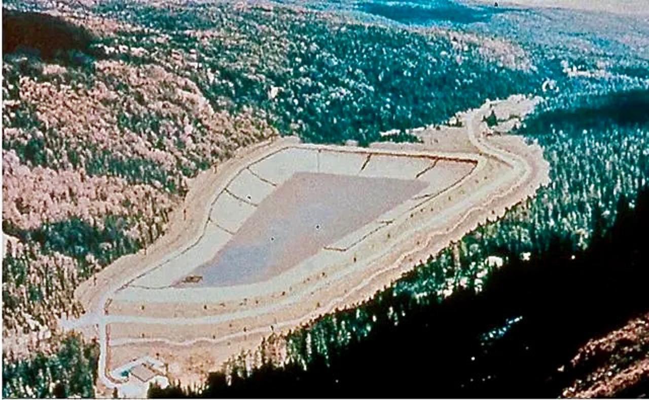 An illustration showing what the proposed New World tailings pond would have generally looked like in the drainage where it would have been located—a drainage where melting snowpack and rain pushes through lots of water and saturated the ground in an area prone of earthquakes. Had a breach of the tailing impoundment occurred, the fear was it would send pollution into streams leading to the Clark's Fork of the Yellowstone River. Meanwhile, old mining wastes on nearby Henderson Mountain posed a potential risk of reaching the Lamar River in Yellowstone. Photo courtesy Mike Clark/MSU Library Archives Special Collection