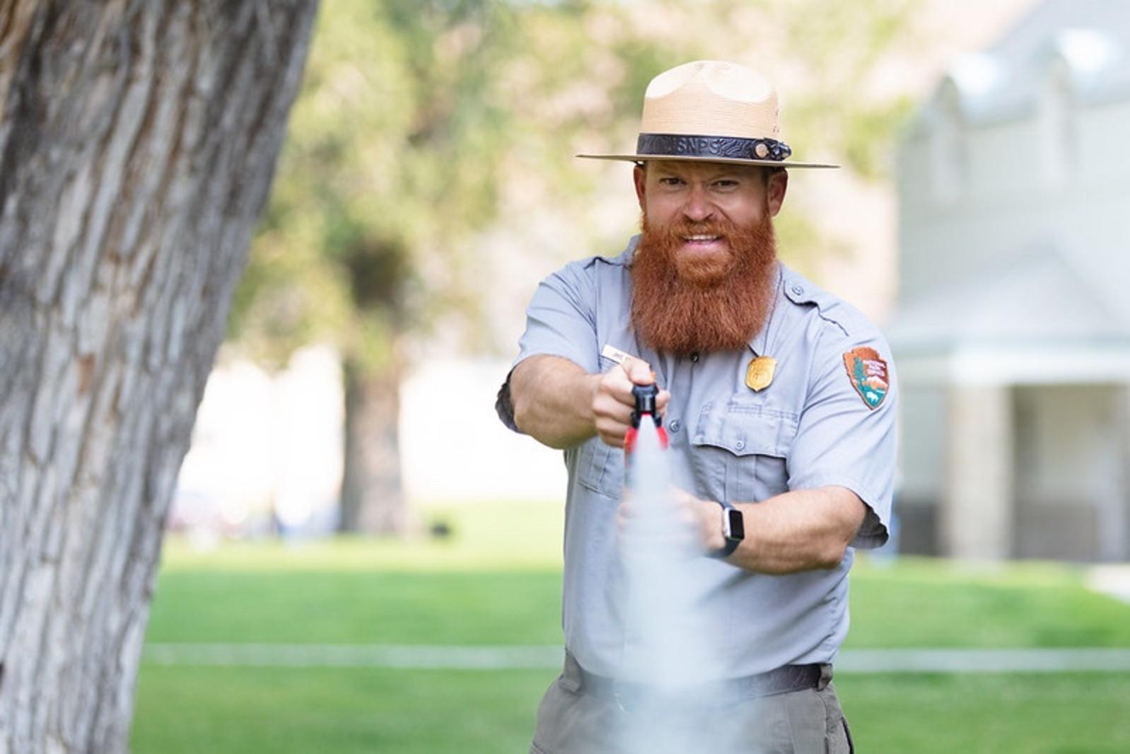 Pretend you're the charging grizzly: A park ranger in Yellowstone demonstrates how to use a can of bear spray. Photo courtesy NPS
