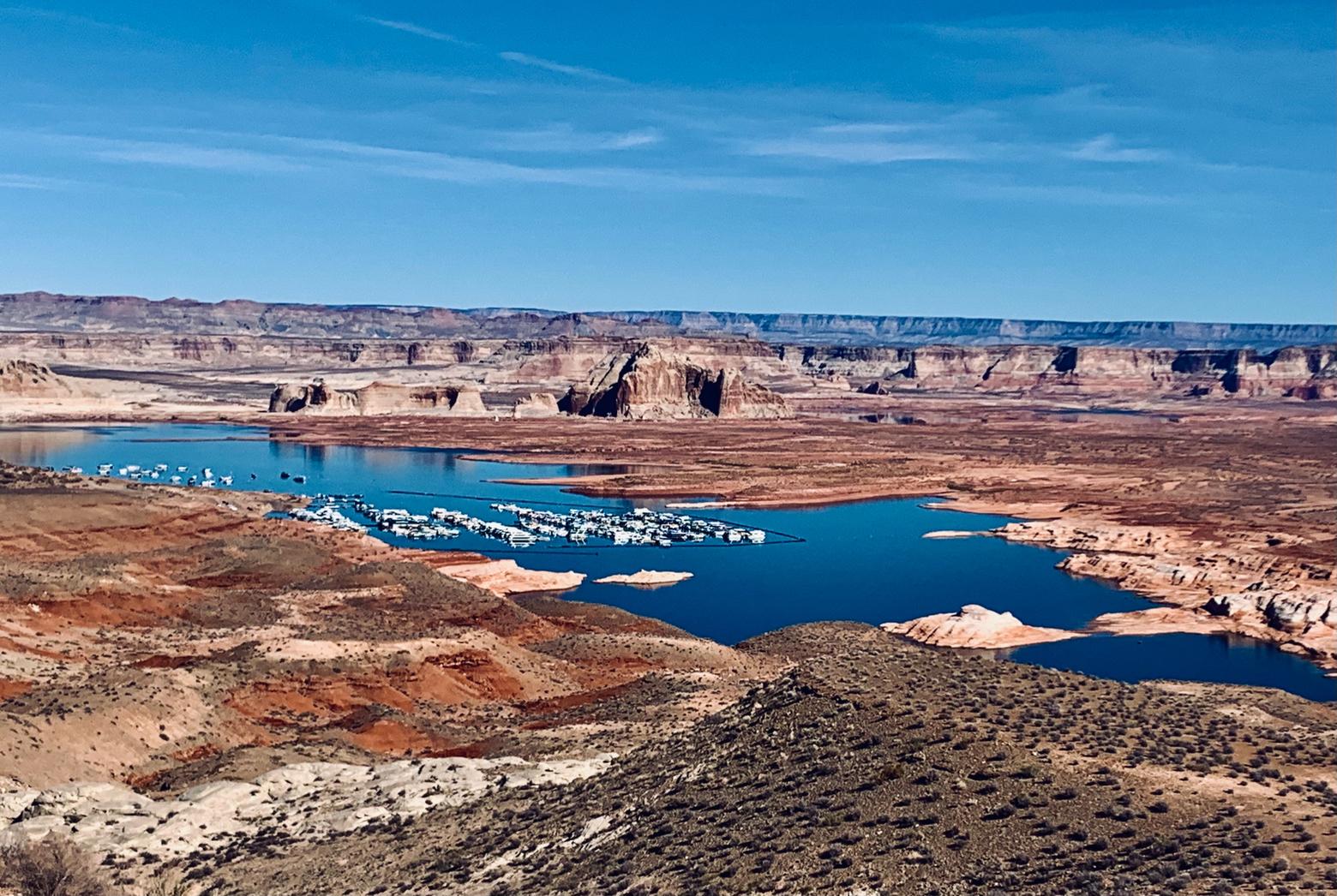 Lake Powell in southern Utah, November 2021. The artificial reservoir, backed up behind Glen Canyon Dam, is today just 28 percent of "full pool" and is a flashing warning sign of droughts related to climate change, experts say. Tens of millions of Americans get the water they drink and use from the Colorado River.  Busse says that rational discussions about climate change and conservation have been coopted by the same propaganda specialists who are using guns as a wedge issue to divide America in order to benefit corporate interests. Photo by Todd Wilkinson