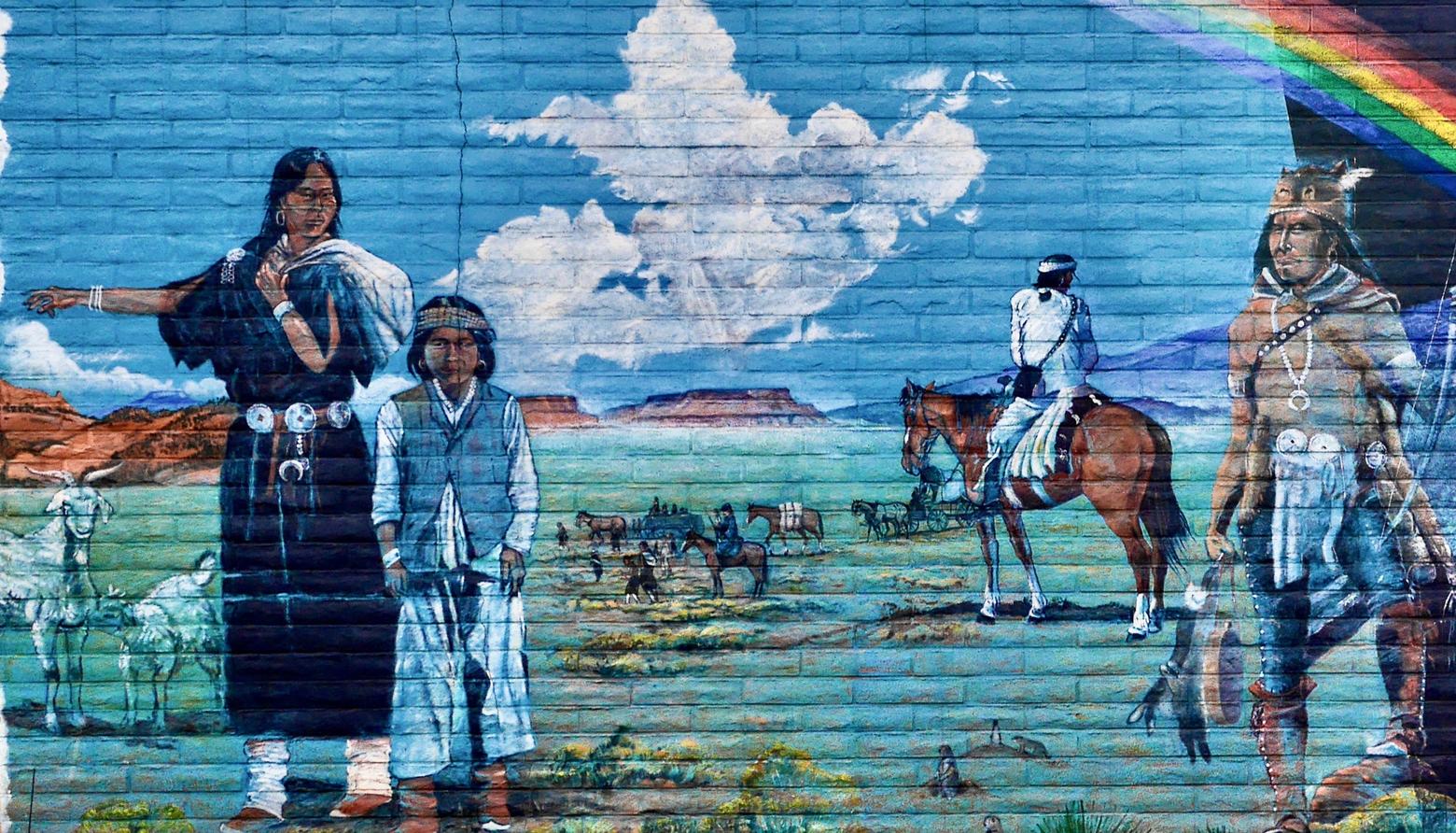 A mural in Gallup, New Mexico titled "Long Walk Home" by Richard K. Yazzir. The work commemorates the return of 7,000 Navajo to their homeland after they were imprisoned for four years (1864-1868).  Image courtesy Creative Commons CC-2.0