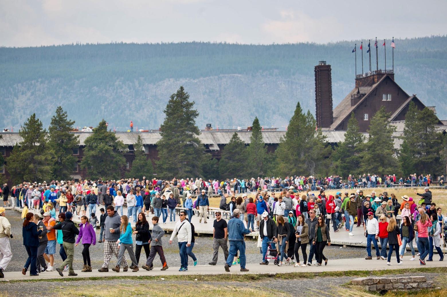 Crowds gather or leave following an eruption of Old Faithful Geyser.  In Yellowstone in 2021, the park notched a record 4.86 million visits and that didn't even include international bus tour traffic which has not been present during Covid. The time of intense visitation has expanded well beyond the Memorial Day to Labor Day stretch in both Yellowstone and Jackson Hole. Photo courtesy Jacob W. Frank/NPS
