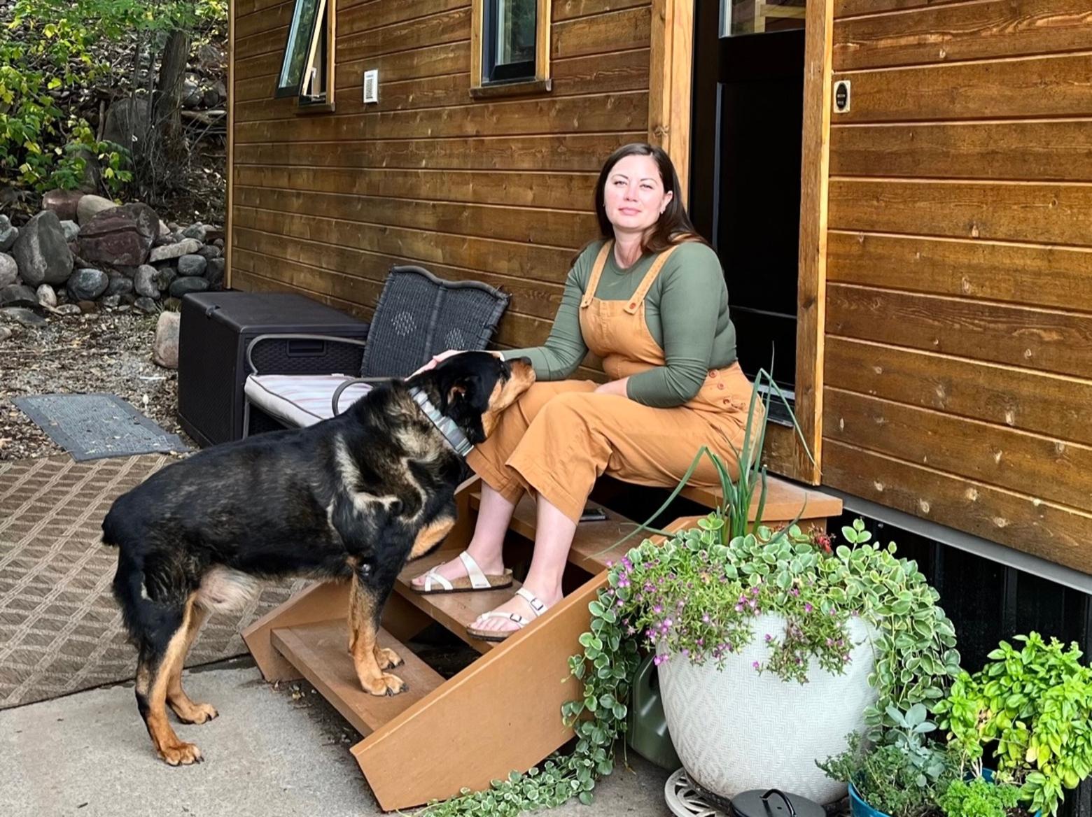 Candace McNatt and dog on the stoop of her home in Durango, Colorado's Oasis Park. Her neighborhood is nicknamed "tiny town" because of the number of tiny homes. Photo courtesy Candace McNatt