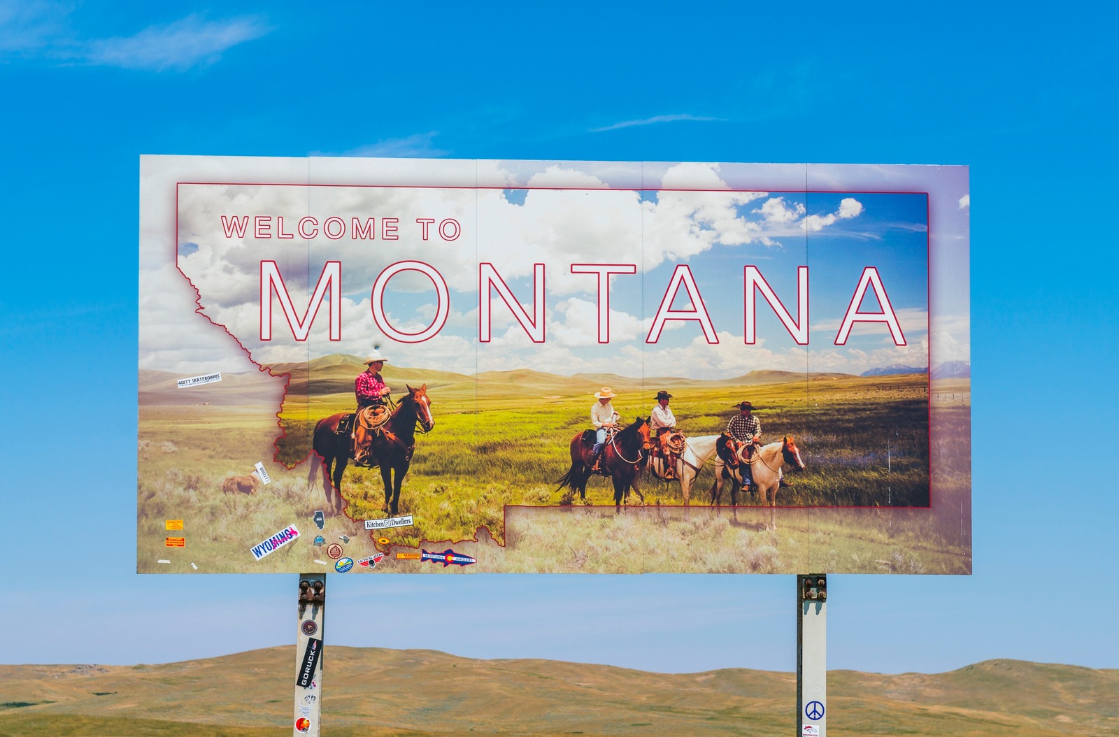 Soon, in some valleys of Greater Yellowstone where ranches are being replaced by subdivisions, will cowboys only appear on billboards promoting tourism? Photo courtesy Shutterstock ID 1219929058/Checubus 
