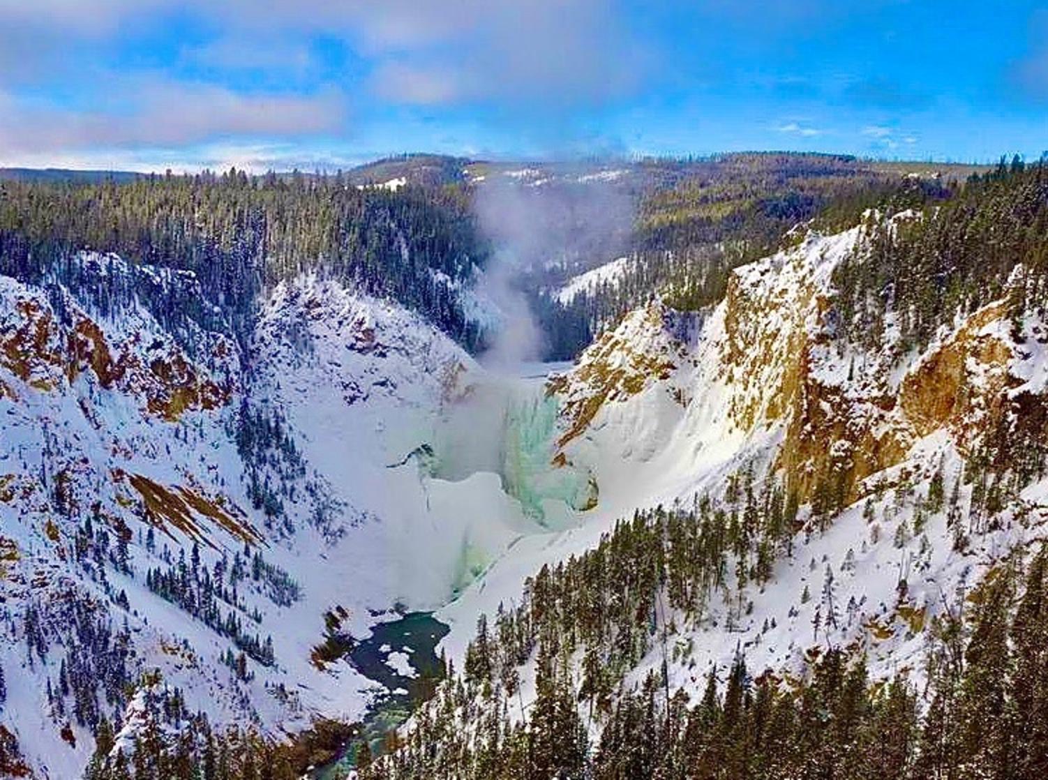 A view painted by Thomas Moran more than 150 years ago, the Grand Canyon of the Yellowstone is captured here in winter by Steve Fuller. The Canyon rim is only a short walk from his winterkeeper's residence. Note how the mighty Lower Falls, three times taller than Niagara, is sheathed in ice.  Photo courtesy Steven Fuller