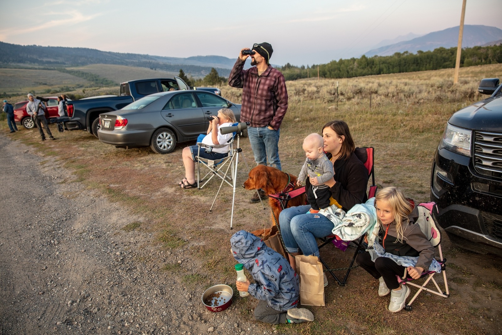 Holly and Charley May sit with their three children and dog, Maverick, on the side of the Tom Miner Basin county road watching grizzly bears in the distance in September, 2022. The Mays are from Livingston, Montana, and for six years they’ve kept an annual tradition to see the bears each fall.