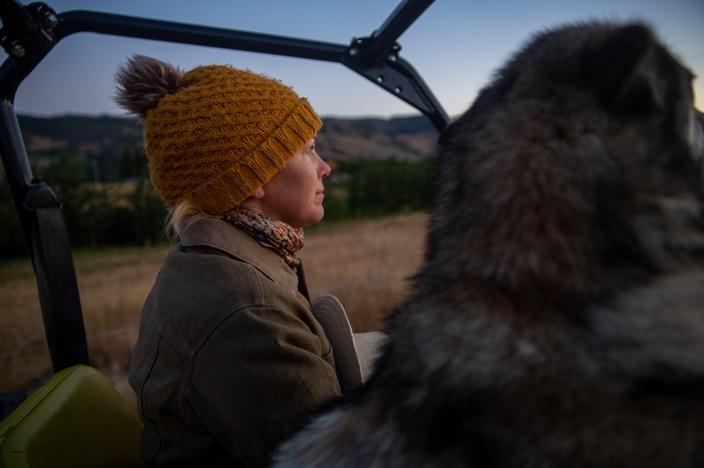 Malou Anderson-Ramirez drives to get the herd of horses on an August morning with ranch dog, Sage, on her family’s ranch in Tom Miner Basin, Montana. 