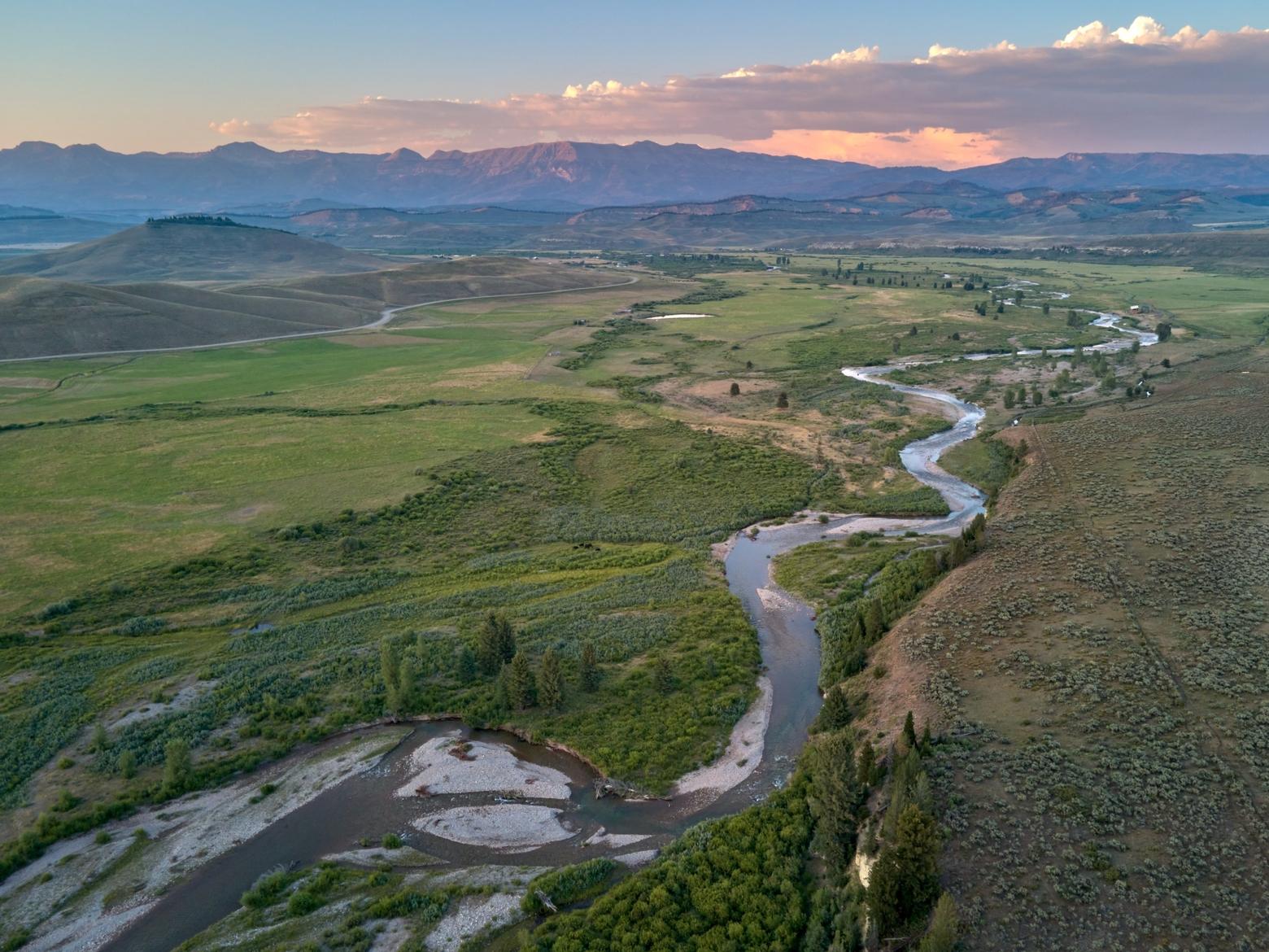 The Hoback River, a 55-mile long tributary of the Snake River, flows toward the Gros Ventre Range in northwestern Wyoming. Until about 20 years ago, most of the Hoback River Valley consisted of ranchlands, writes Susan Marsh. Then a ranch was purchased and subdivided. Are the flood gates now open? Photo by Jon Mullen/Ecostock