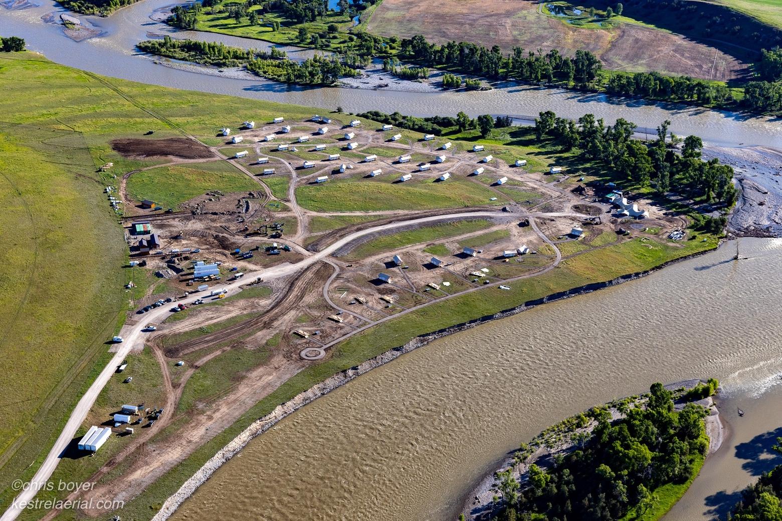 When residents of Livingston, Montana saw this image for the first time, they were stunned. A new multi-unit glampground and its accompanying infrastructure is now saddled near the banks of the Yellowstone River in Paradise Valley, made vivid in this photograph by Christopher Boyer of Kestrel Aerial.  The glampground is a symbol of the rapidly expanding natural amenity economy whose strongest advocates have been traditional conservation organizations. Many of those organizations have been absent from county planning and zoning discussions so important in bringing scrutiny to projects like this.