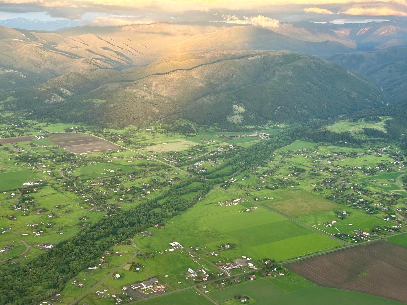 Once upon a time, members of a famous elk herd could wander easily through it. This bird's-eye view can't hide the impact of rural sprawl rapidly filling the southern Gallatin Valley outside of Bozeman, on the edge of the Gallatin Range. The proposed gravel pit is proposed to be dug into pastoral land just north of here and out of the picture. It is another example of how former farm land, with some of the richest, deepest soils in the state and important habitat for wildlife is getting covered—a consequence of weak land use planning and zoning being exploited by developers in Big Sky, citizens say. Photo by Todd Wilkinson