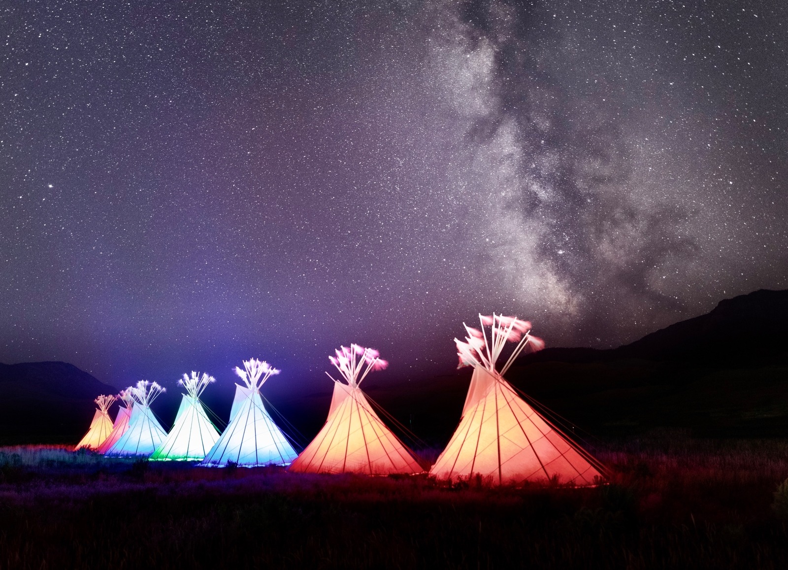 Glowing teepees return to the front doorstep of Yellowstone at Roosevelt Arch on the edge of Gardiner, Montana. They're a reminder of how the lands that became Yellowstone have their own history with different tribes across time and space. Photo courtesy Jacob W. Frank/NPS