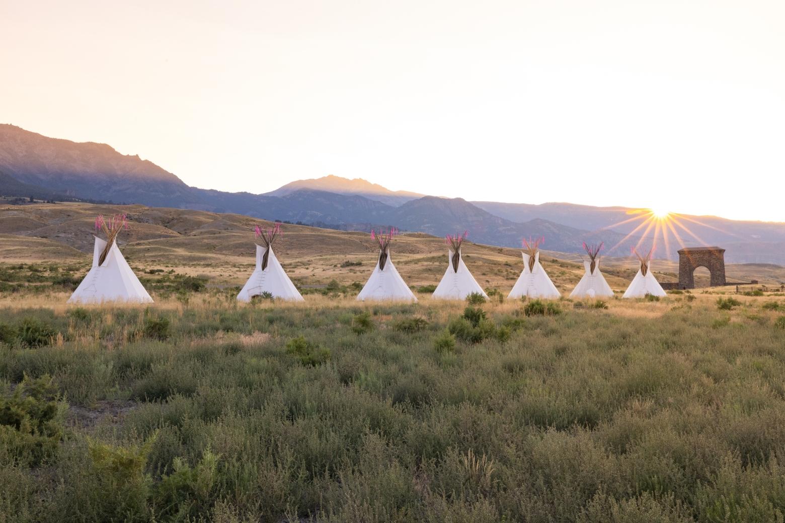 Yellowstone Revealed: North Entrance teepees at sunset with Roosevelt Arch in the background, August 2022. Photo by Jacob W. Frank