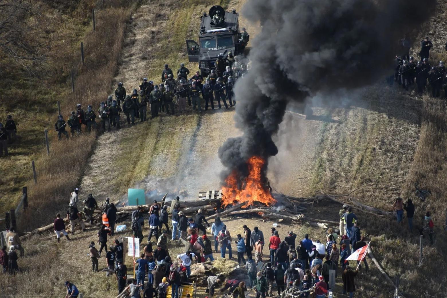 Protesters at the Standing Rock demonstrations in 2016 protesting the Dakota Access Pipeline blocked a road to slow police advancement. Sarah Comeau attended the protests. Law enforcement photo 