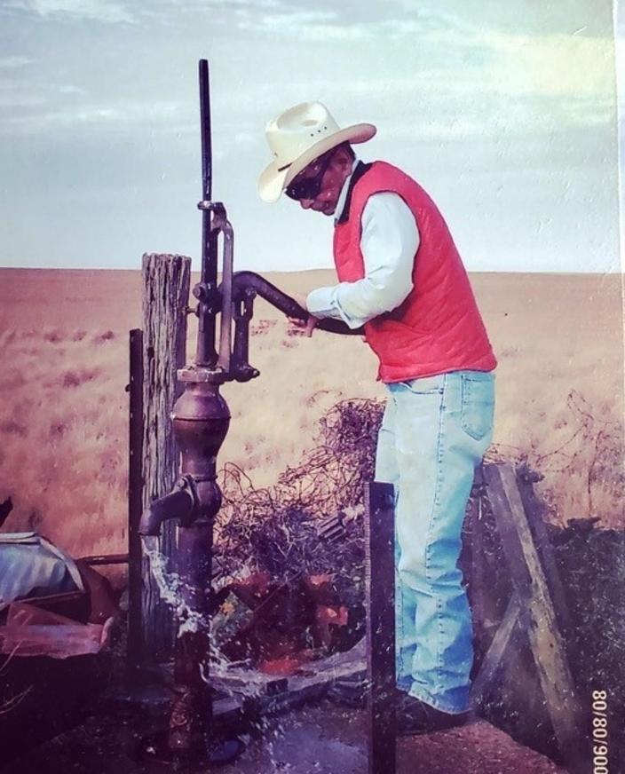 The writer's grandfather, Ken Ward, checks a water pump on his South Dakota ranch. Photo courtesy Sarah Comeau