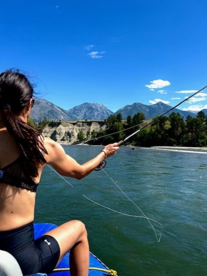 The writer reflects on the water as she casts  into the Yellowstone River. Photo courtesy Sarah Comeau